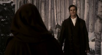 Movie still from “Mirror Mirror” (2012), directed by Tarsem Singh – A man in a brown coat and a woman in a brown robe; Medium shot, Over the shoulder angle