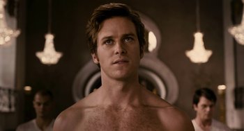 Movie still from “Mirror Mirror” (2012), directed by Tarsem Singh – A man with no shirt is looking at the camera; Close Up shot, Low angle