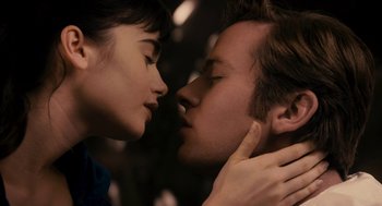 Movie still from “Mirror Mirror” (2012), directed by Tarsem Singh – A man and a woman are kissing in the dark; Close Up shot, Overhead angle