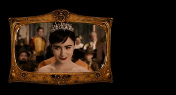 Movie still from “Mirror Mirror” (2012), directed by Tarsem Singh – A woman with a tiara in front of a mirror; Close Up shot, Over the shoulder angle