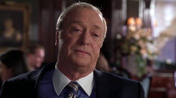 Movie still from “Miss Congeniality” (2000), directed by Donald Petrie – An older man wearing a suit and tie; Close Up shot, Over the shoulder angle