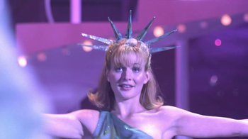 Movie still from “Miss Congeniality” (2000), directed by Donald Petrie – A woman in a statue of liberty headpiece; Medium shot, Low angle