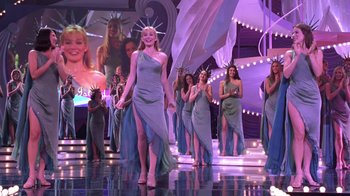 Movie still from “Miss Congeniality” (2000), directed by Donald Petrie – A group of women in long dresses on a runway; Wide shot, Low angle