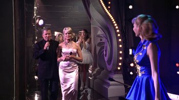 Movie still from “Miss Congeniality” (2000), directed by Donald Petrie – A group of people standing in front of a stage; Medium shot, Over the shoulder angle