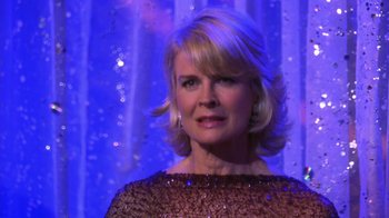 Movie still from “Miss Congeniality” (2000), directed by Donald Petrie – A woman with blonde hair wearing a brown dress; Close Up shot, Over the shoulder angle