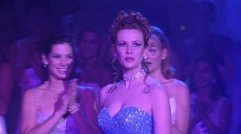 Movie still from “Miss Congeniality” (2000), directed by Donald Petrie – A group of women standing next to each other in a room; Medium shot, Low angle