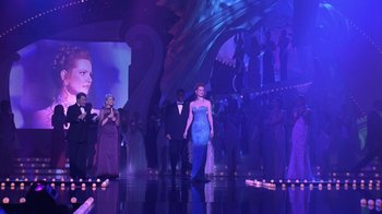 Movie still from “Miss Congeniality” (2000), directed by Donald Petrie – A woman in a blue dress walking down a runway; Wide shot, Over the shoulder angle