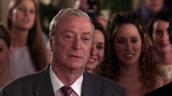 Movie still from “Miss Congeniality” (2000), directed by Donald Petrie – An older man wearing a suit and tie; Close Up shot, Over the shoulder angle