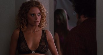 Movie still from “Love & Other Drugs” (2010), directed by Edward Zwick – A woman in a black bra looking at a man in front of a mirror; Close Up shot, Over the shoulder angle