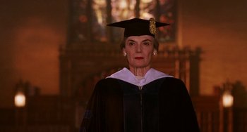 Movie still from “Mona Lisa Smile” (2003), directed by Mike Newell – An older woman in a graduation cap and gown; Medium shot, Low angle