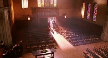 Movie still from “Mona Lisa Smile” (2003), directed by Mike Newell – A large room with many rows of chairs and a table; Extreme Wide shot, High angle