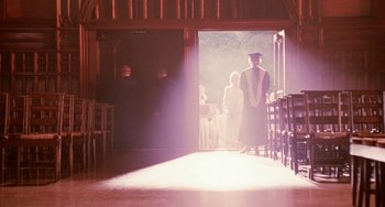 Movie still from “Mona Lisa Smile” (2003), directed by Mike Newell – A group of people standing in front of an open door; Wide shot, Over the shoulder angle