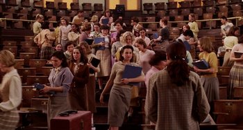 Movie still from “Mona Lisa Smile” (2003), directed by Mike Newell – A group of people standing in front of a crowd; Wide shot, High angle