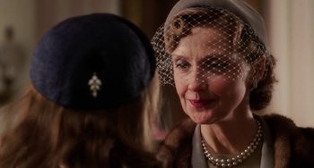 Movie still from “Mona Lisa Smile” (2003), directed by Mike Newell – An older woman wearing a hat and a veil; Close Up shot, Over the shoulder angle