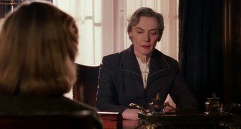 Movie still from “Mona Lisa Smile” (2003), directed by Mike Newell – An older woman sitting at a table in front of another woman; Medium shot, Over the shoulder angle