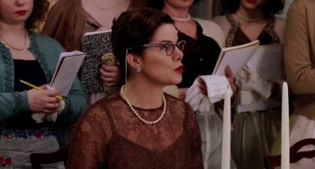 Movie still from “Mona Lisa Smile” (2003), directed by Mike Newell – A group of women in formal attire holding papers; Close Up shot, Over the shoulder angle