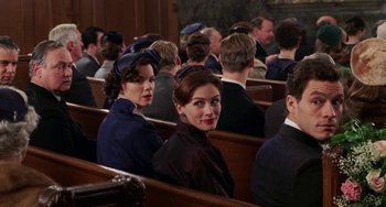 Movie still from “Mona Lisa Smile” (2003), directed by Mike Newell – A group of people sitting in pews in a church; Medium shot, High angle
