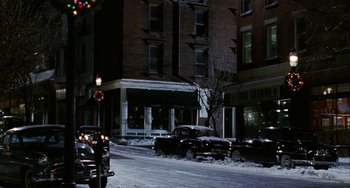 Movie still from “Mona Lisa Smile” (2003), directed by Mike Newell – Cars parked on the side of the street in the snow; Extreme Wide shot, High angle