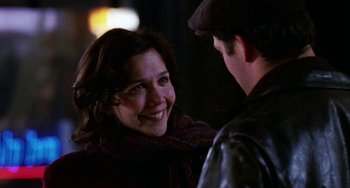 Movie still from “Mona Lisa Smile” (2003), directed by Mike Newell – A man and a woman smiling at each other; Close Up shot, Over the shoulder angle