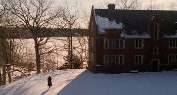 Movie still from “Mona Lisa Smile” (2003), directed by Mike Newell – A person walking in front of a house in the snow; Extreme Wide shot, High angle