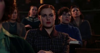 Movie still from “Mona Lisa Smile” (2003), directed by Mike Newell – A group of people sitting in a room; Medium shot, Over the shoulder angle