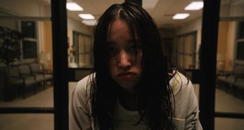 Movie still from “Mona Lisa and the Blood Moon” (2021), directed by Ana Lily Amirpour – A woman with long black hair is looking at the camera; Close Up shot, Low angle