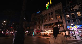 Movie still from “Mona Lisa and the Blood Moon” (2021), directed by Ana Lily Amirpour – A woman standing on the side of a street at night; Extreme Wide shot, Low angle