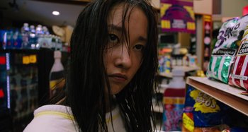 Movie still from “Mona Lisa and the Blood Moon” (2021), directed by Ana Lily Amirpour – A woman with long black hair is looking at the camera; Close Up shot, Low angle