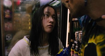 Movie still from “Mona Lisa and the Blood Moon” (2021), directed by Ana Lily Amirpour – A young woman with long black hair looking into the distance; Close Up shot, Low angle