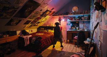Movie still from “Mona Lisa and the Blood Moon” (2021), directed by Ana Lily Amirpour – A person walking in a room with a bed and a desk; Extreme Wide shot, High angle