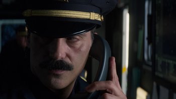 Movie still from “Money Monster” (2016), directed by Jodie Foster – A person talking on a phone; Close Up shot, Low angle