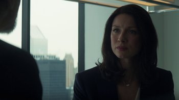 Movie still from “Money Monster” (2016), directed by Jodie Foster – A woman in a suit looking out of a window; Close Up shot, Over the shoulder angle
