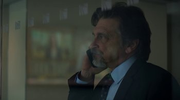 Movie still from “Money Monster” (2016), directed by Jodie Foster – A person talking on a cell phone; Close Up shot, Low angle
