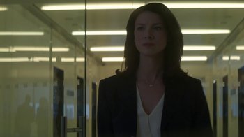 Movie still from “Money Monster” (2016), directed by Jodie Foster – A woman standing in front of a mirror in a room; Medium shot, Low angle