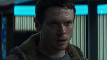 Movie still from “Money Monster” (2016), directed by Jodie Foster – A person wearing a jacket; Close Up shot, Over the shoulder angle