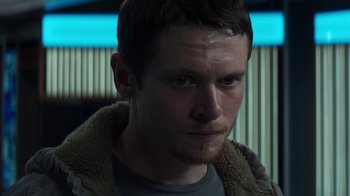 Movie still from “Money Monster” (2016), directed by Jodie Foster – A person wearing a jacket; Close Up shot, Low angle