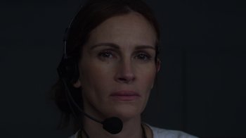 Movie still from “Money Monster” (2016), directed by Jodie Foster – A woman wearing a headset looking into the distance; Close Up shot, High angle