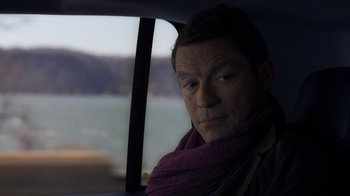 Movie still from “Money Monster” (2016), directed by Jodie Foster – A man sitting in the back seat of a car looking out the window; Close Up shot, Over the shoulder angle
