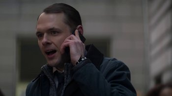 Movie still from “Money Monster” (2016), directed by Jodie Foster – A man talking on a cell phone while wearing a jacket; Close Up shot, Low angle
