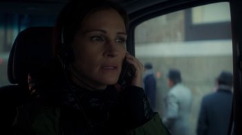 Movie still from “Money Monster” (2016), directed by Jodie Foster – A woman in a car talking on a cell phone; Close Up shot, Over the shoulder angle