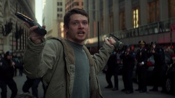 Movie still from “Money Monster” (2016), directed by Jodie Foster – A man holding a cell phone in his hand; Medium shot, Low angle