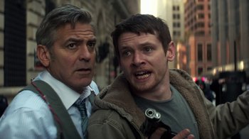 Movie still from “Money Monster” (2016), directed by Jodie Foster – A man and a man with a camera in a city street; Close Up shot, Low angle
