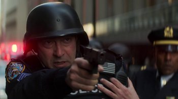 Movie still from “Money Monster” (2016), directed by Jodie Foster – A man wearing a helmet and holding a gun; Close Up shot, Low angle