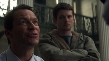 Movie still from “Money Monster” (2016), directed by Jodie Foster – Two men sitting next to each other in a room; Close Up shot, Low angle