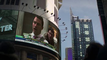Movie still from “Money Monster” (2016), directed by Jodie Foster – Two men are on a large screen in a city; Extreme Close Up shot, Over the shoulder angle