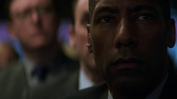 Movie still from “Money Monster” (2016), directed by Jodie Foster – A man's face in a crowd; Close Up shot, Over the shoulder angle