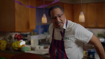 Movie still from “Monster High: The Movie” (2022), directed by Todd Holland – A man in a white shirt and a red and blue striped apron; Medium shot, Low angle