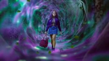 Movie still from “Monster High: The Movie” (2022), directed by Todd Holland – A woman is walking through a tunnel with a bag; Wide shot, Overhead angle