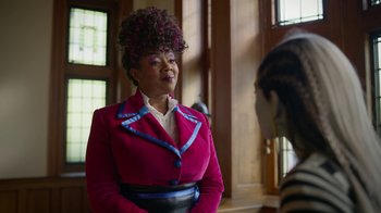 Movie still from “Monster High: The Movie” (2022), directed by Todd Holland – A woman in a pink jacket talking to another woman; Medium shot, Over the shoulder angle