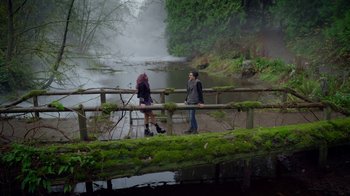 Movie still from “Monster High: The Movie” (2022), directed by Todd Holland – A man and a woman walking across a bridge over a river; Wide shot, High angle